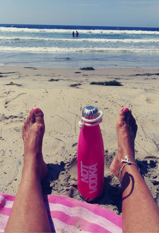 loreen's feet and water bottle  at beach