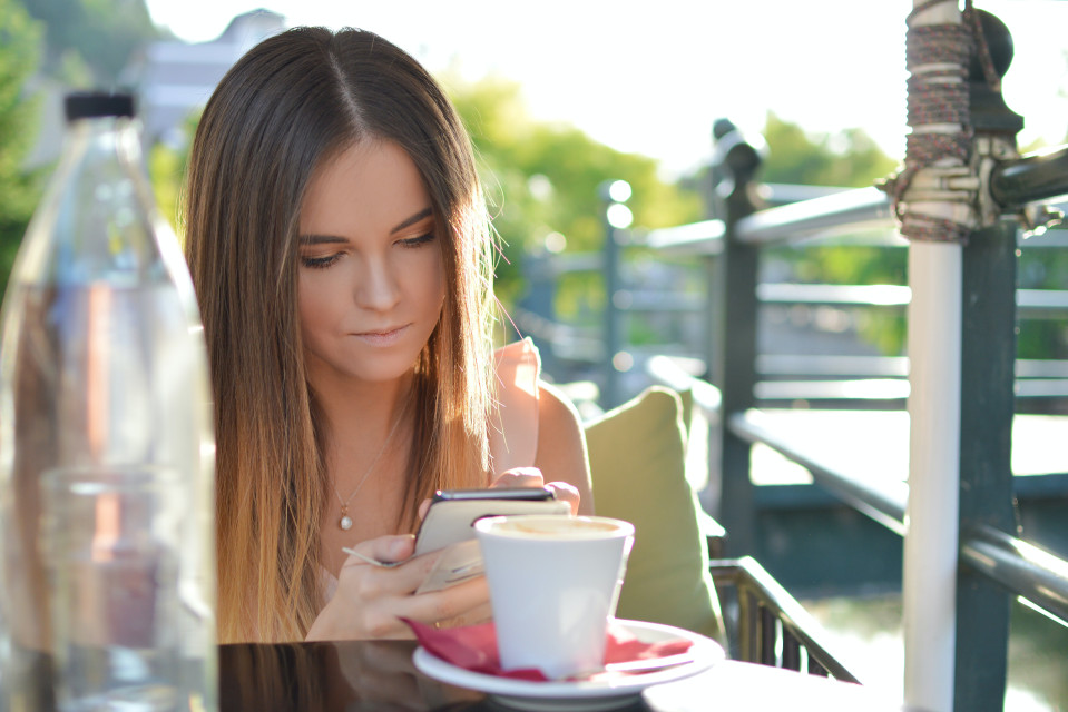 woman scrolling on her cell phone