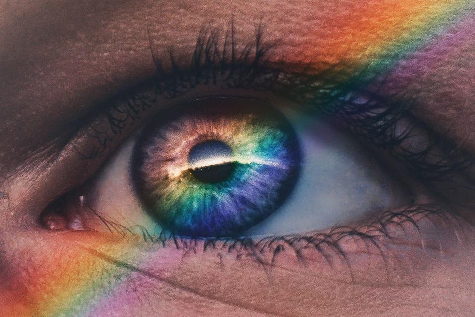 eye with rainbow colors shining over it
