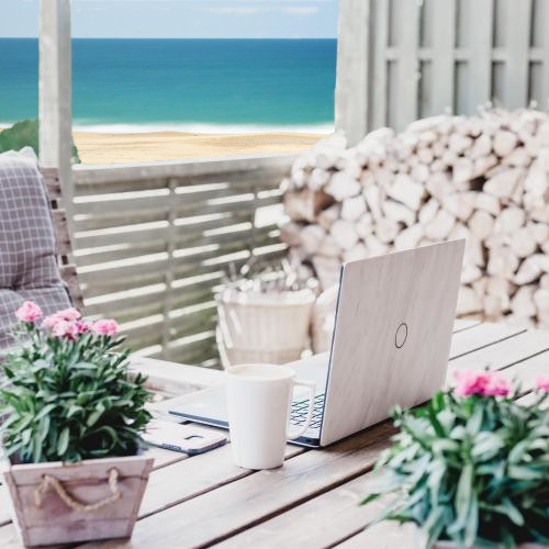 laptop on ocean front patio table