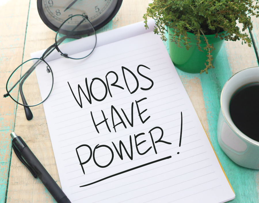 words have power written on tablet with plant, glasses, coffee, pen, clock